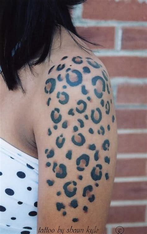 leopard spots tattoo down spine.